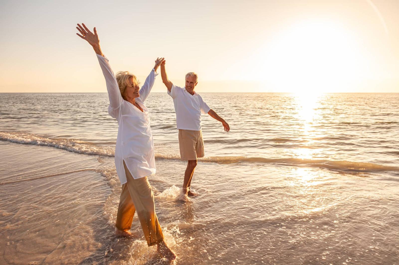 Older couple walking on the beach